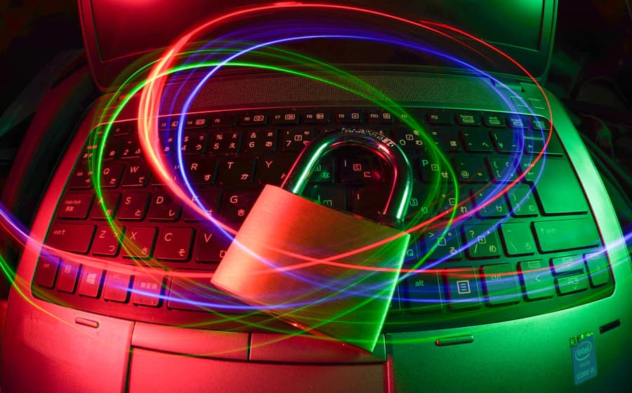 A padlock protecting a laptop from online security threats
